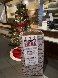 Picture of a donation box in front of a Christmas tree located in the Providence, Chelo's Restaurant location.